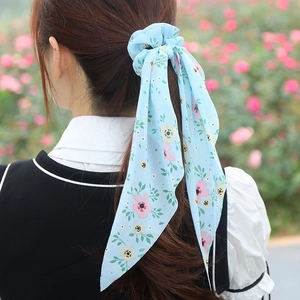 Floral print chiffon scrunchie with long ribbons in light blue and pink on model