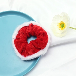 Festive red velvet Christmas scrunchie with white plush trim on a decorative tray
