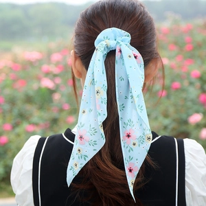 Floral chiffon hair scrunchie with long ribbon streamers for elegant ponytails