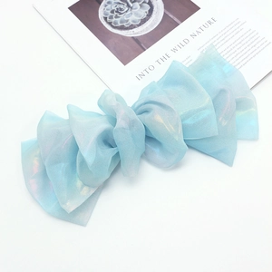 Detailed close-up of blue iridescent organza fabric with multilayered ruffle design