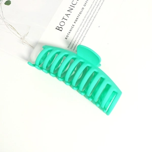 Detail of mint green matte claw clip with non-slip shark bone structure for thick hair