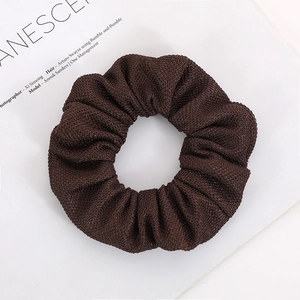 Deep brown waffle knit scrunchie with thick texture for a stylish hair accessory style