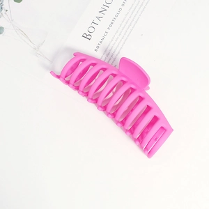 Detail of 14cm matte pink shark hair claw clip showing textured matte surface and sturdy teeth