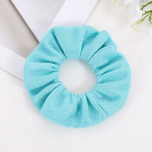 Detail of light blue scrunchie with textured mesh fabric and elastic hair band