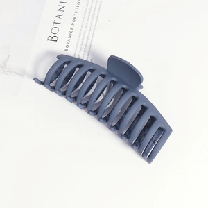 Detail of 14cm matte navy blue claw clip on minimalist fashion magazine background