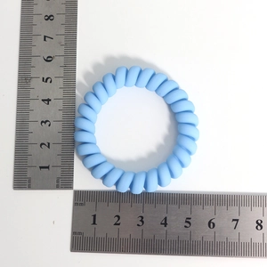Blue spiral hair tie with matte texture shown with a ruler for 5.5cm size measurement