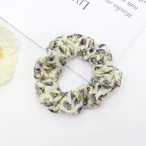 Detailed macro shot of floral scrunchie with cream fabric and high elastic band