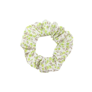 Floral print scrunchie with green flower pattern on white fabric for women hair styling