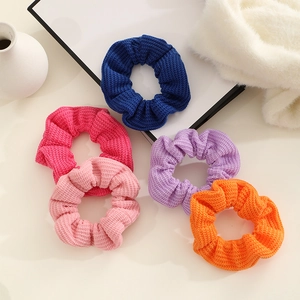 5-piece set of knitted scrunchies in navy, pink, purple, and orange textured fabric