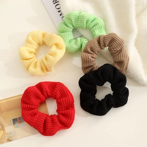 Five-pack of rib-knit scrunchies in red, black, brown, green, and beige on a white background