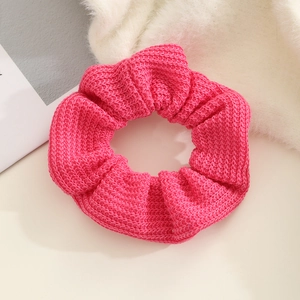 Detailed close-up of rose pink knitted scrunchie showing fine texture and premium elastic