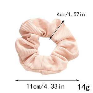 Pink scrunchie hair tie with ribbed fabric texture and 11cm diameter dimensions