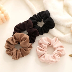 Set of four vintage ribbed fabric scrunchies in black, coffee, mocha, and pastel pink colors