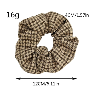 Macro detail showing houndstooth scrunchie size of 12cm diameter and 16g weight info