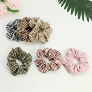 Five-pack of houndstooth scrunchies in various colors for elegant hair styling