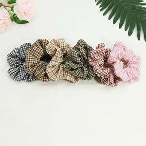 6-piece set of houndstooth fabric hair scrunchies in vintage colors on a white background