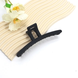 Macro shot of 14cm matte black hair claw clip showing smooth texture and minimal design