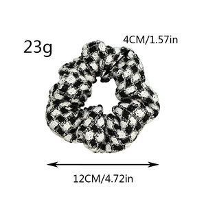 Detailed view of black and white plaid scrunchie with 12cm diameter and 23g weight