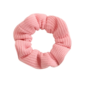 Pink knit waffle texture scrunchie with soft elastic hair tie for elegant ponytails
