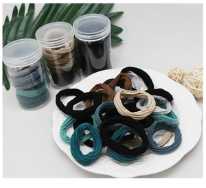 Detail of high-elasticity ribbed hair ties in earthy tones with plastic storage jars