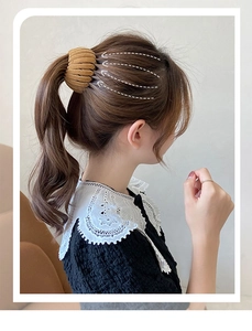 Close-up of a camel velvet bird nest hair clip securing a ponytail on a model