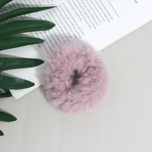 Primo piano dell'elastico per capelli in finta pelliccia rosa chiaro con morbida trama