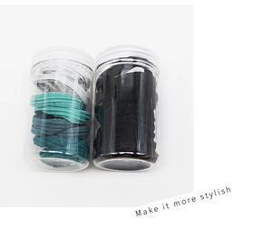 Detail view of seamless hair ties in transparent storage jars with screw lids