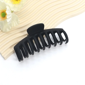 Close-up of a large black matte hair claw clip with powerful spring and interlock teeth