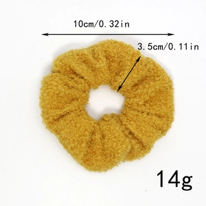 Detail view of yellow faux shearling hair scrunchie showing dimensions 10cm and weight 14g