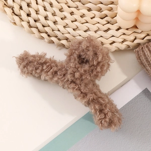 Close-up of soft brown lamb wool texture on large hair claw clip for autumn style