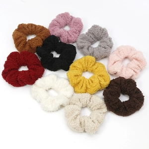 Set of 10 colorful sherpa fleece scrunchies in various autumn shades on white background