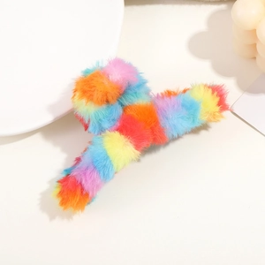 Detail showing the soft fluffy texture and vibrant rainbow plush of this large hair claw clip