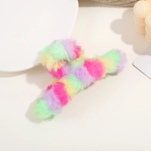 Close-up of rainbow plush hair claw clip featuring soft faux fur in pastel colors