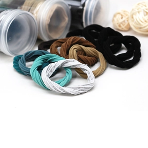Seamless ribbed elastic hair ties in multi-color set with a clear cylinder storage jar