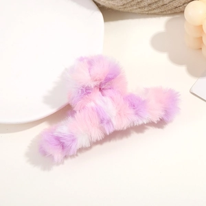 Macro shot of colorful plush hair claw clip in purple, pink and white tones