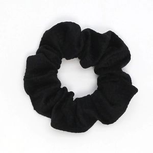 Detail shot of the textured black checkered velvet fabric on this classic hair scrunchie