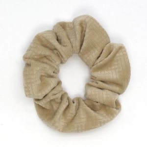 Detail of beige velvet scrunchie showing the thick textured woven fabric and soft texture