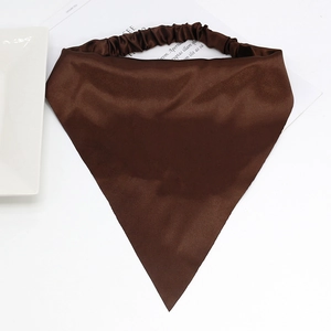Flat lay of brown satin triangle headscarf with elastic band on a white table set