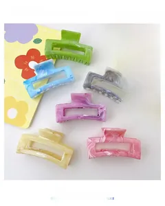Macro detail of assorted colorful marble texture acetate hair claws for girls