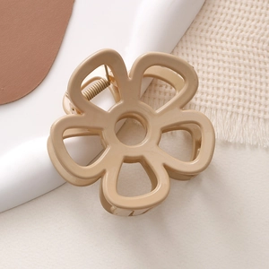 Detailansicht der blumenförmigen Harz-Haarklammer in Beige mit einer stabilen Metallfeder