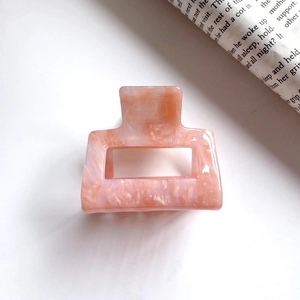 Medium square marble pattern hair claw clip in orange pink resin with glossy finish