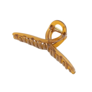 Oversized amber acrylic claw clip with twisted design and gold spring for thick hair