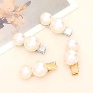 Elegant gold and silver pearl hair clips set for women on minimalist textured background