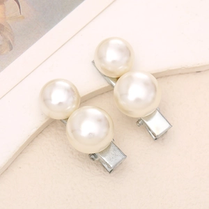 Close-up of elegant pearl hair clips with silver metal duckbill base for women