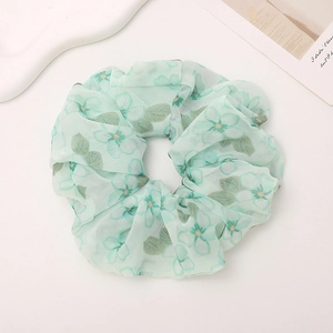 Elegant mint green floral chiffon scrunchie with leaf patterns for hair styling