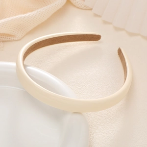 Detail of cream matte faux leather headband with non-slip lining on ceramic bowl