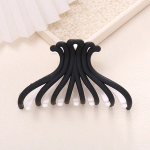Minimalist black and white color block shark hair claw clip with a matte frosted finish