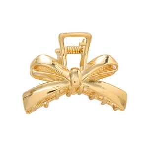 Elegant gold bow-shaped hair claw clip in polished metal for women hairstyles