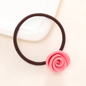French style pink rose flower hair tie with high elastic brown cord on a white tray