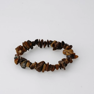 Macro detail of natural irregular tiger eye stone fragments on an elastic bracelet